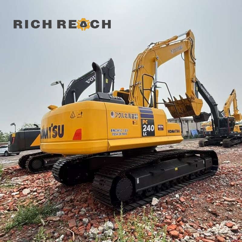 Side profile of a 2018 Komatsu PC240LC excavator showing the boom and arm, $34,722